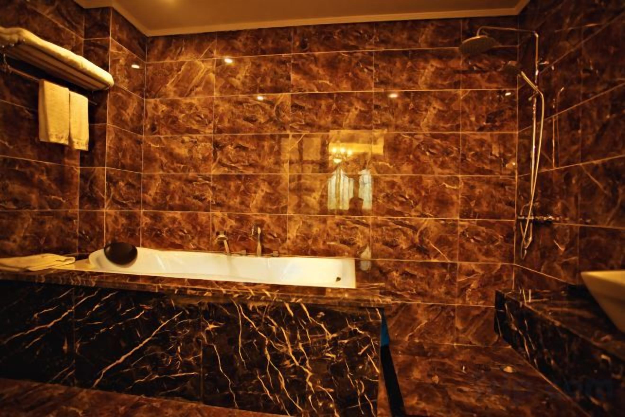 A bathroom with a marble sink, a bathtub, and a shower.