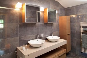 A modern bathroom with two large white sinks, a wooden vanity, and a built-in mirror. - Logis Hotel la Source Bleue (Gudmont)