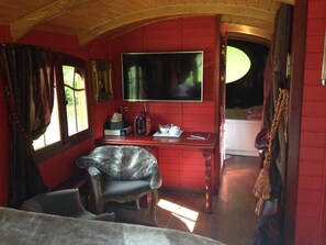 A room with a television, a desk, a chair, and a window with curtains. - Logis Hotel la Source Bleue (Gudmont)