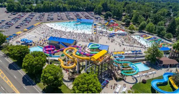 An aerial view of a water park with multiple water slides and a large swimming pool. - Serenity Lakeside Cottage (Edinboro)