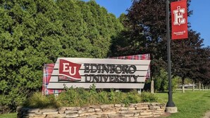 A sign for Edinboro University with a plaid banner and a PennWest® sign. - Serenity Lakeside Cottage (Edinboro)