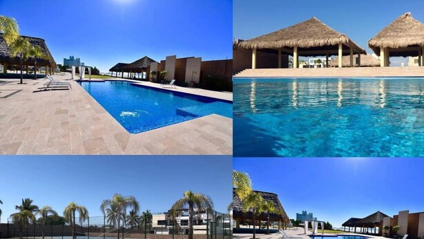A resort with a swimming pool, thatched-roof structures, and palm trees. - CASAS PB (Mazatlán)