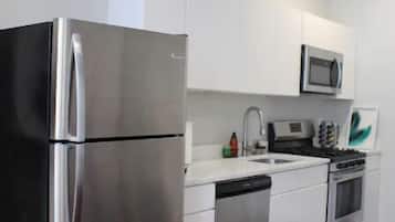 Enjoy cooking in this well-equipped kitchen with a refrigerator, microwave, and dishwasher.