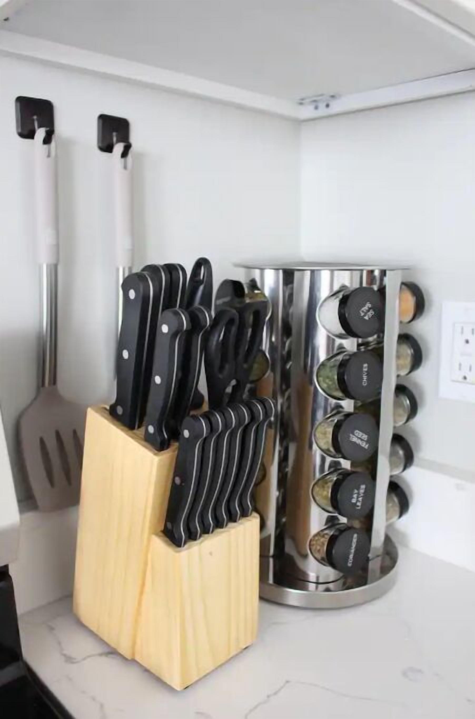 A kitchen counter with a knife block, a spatula, and a spice rack.