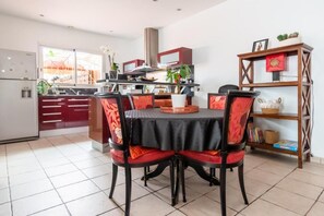 Enjoy meals around the central table with four comfortable chairs.