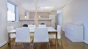 A modern kitchen with white cabinets and a white countertop. - Hurtle Sq Hideaway - Parking, Central, Ground Flr (Adelaide)