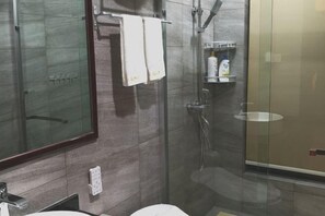 A bathroom with a glass shower enclosure, a mirror, a sink, and a towel rack. - Huaqitang Rural Life Hostel (Wuhan)