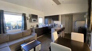 A modern apartment with a living room, kitchen, and dining area. - Vacation rental near Royan in a magnificent setting (sainte gemme)