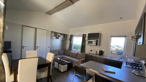 A compact living space with a kitchenette, dining area, and seating. - Vacation rental near Royan in a magnificent setting (sainte gemme)