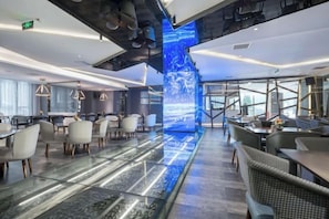 A modern hotel lobby with a digital waterfall display, seating areas, and a staircase leading to upper floors. - Aixi Jialin Hotel(Chongqing Bishan Junhao Central Street Store) (Chongqing)
