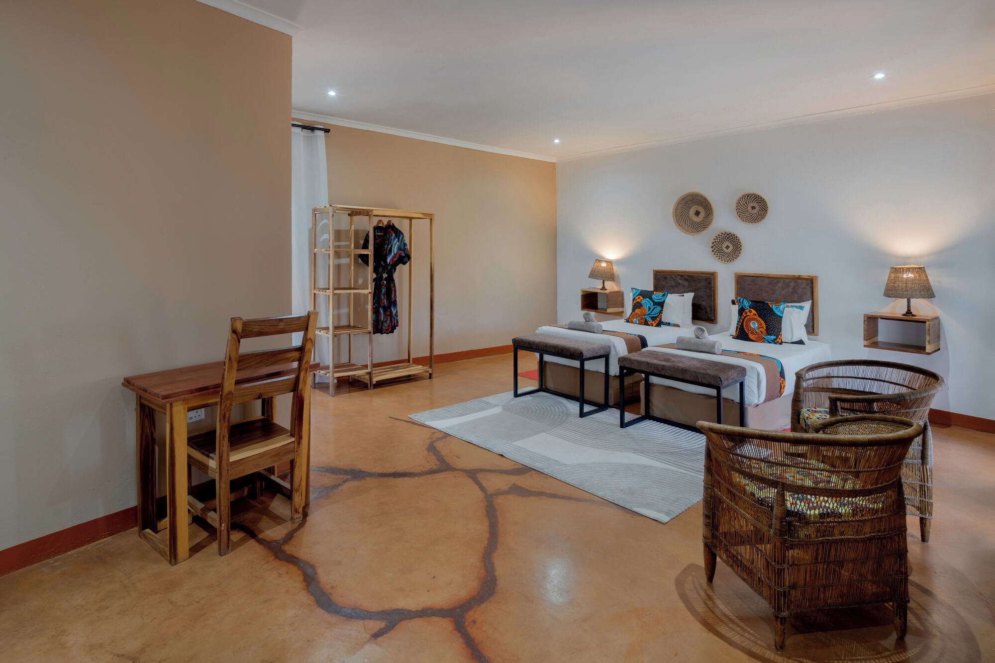 A bedroom with a bed, bedside tables, a chair, a wardrobe, and a mirror.