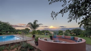 A pool, a curved seating area, and a telescope. - The Nkhosi Livingstone Lodge and Spa (Livingstone)