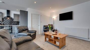 Desk, iron/ironing board, bed sheets