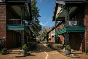 Stroll along the charming pathway lined with lush greenery and ornate balconies.
