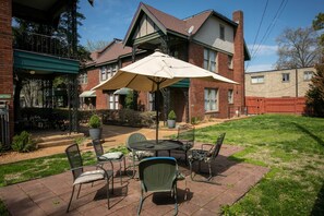 Relax in the comfort of this charming home's patio, complete with a table and chairs.