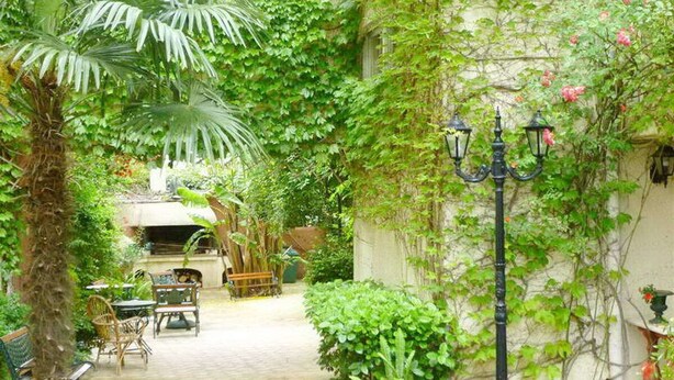 A garden with a paved path, outdoor furniture, and a lamp post. - Apartment 120m2 between sea and mountains in Glyfada, Athens Riviera (Glifada)