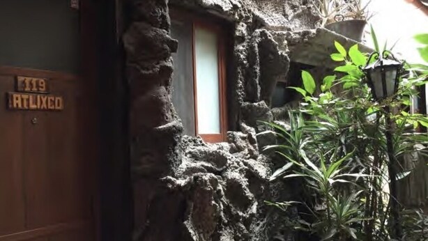 A rustic stone building with a wooden door labeled "119 ATLIXO". - Hotel San Agustin (Puebla)
