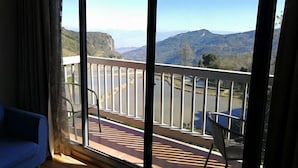 A balcony with a view of mountains and a road. - Jacky's Guesthouse (Yuanyang)