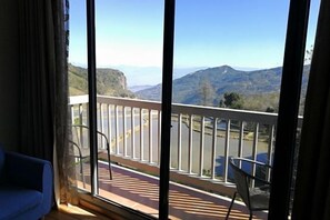 A balcony with a view of mountains and a road. - Jacky's Guesthouse (Yuanyang)