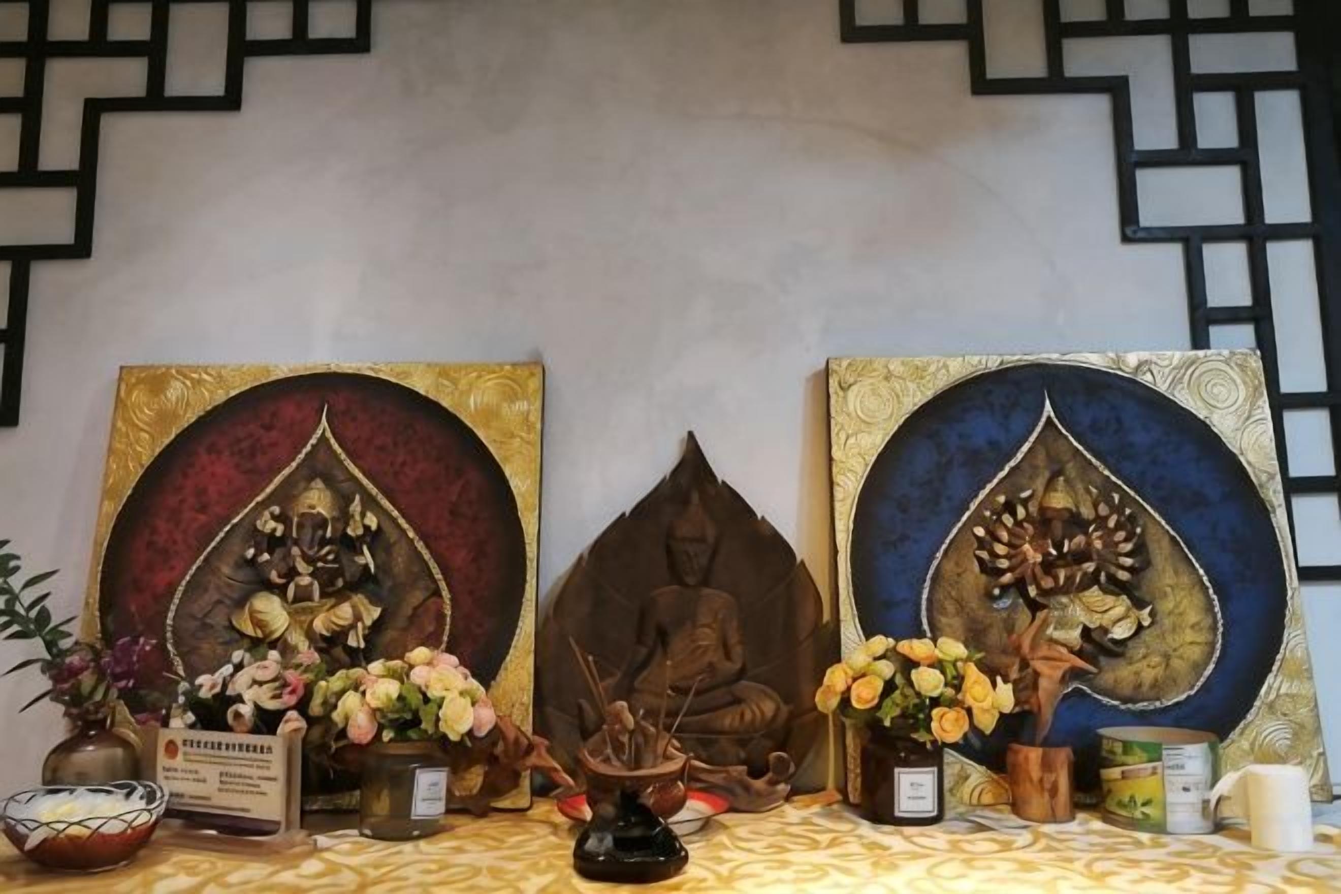 A shrine with statues and offerings, including flowers and incense.