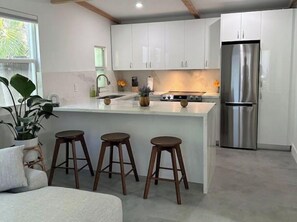 Enjoy cooking in this well-equipped kitchen with a central island and ample natural light.