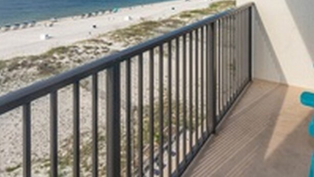 A balcony with a view of a beach and ocean. - Island Winds West by Brett/Robinson Vacations (Gulf Shores)