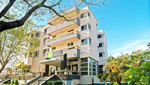 A multi-story hotel with a modern design, featuring balconies, a staircase, and a sign indicating it is a hotel. - Brotnjo (Citluk)