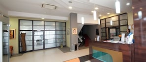 A hotel reception area with a reception desk, a staircase, and a restaurant sign. - Brotnjo (Citluk)