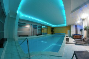 An indoor swimming pool with a tiled floor and a blue-lit ceiling. - Brotnjo (Citluk)