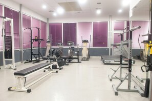A gym with various exercise equipment, including treadmills, weight machines, and a bench. - Brotnjo (Citluk)
