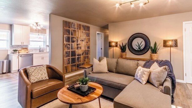 A living room with a sofa, two armchairs, a coffee table, and a decorative wall panel. - Great location, Close to everything in Bentonville (Bentonville)