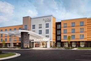 Welcome to Fairfield by Marriott, featuring a contemporary entrance with a covered walkway and multiple windows.
