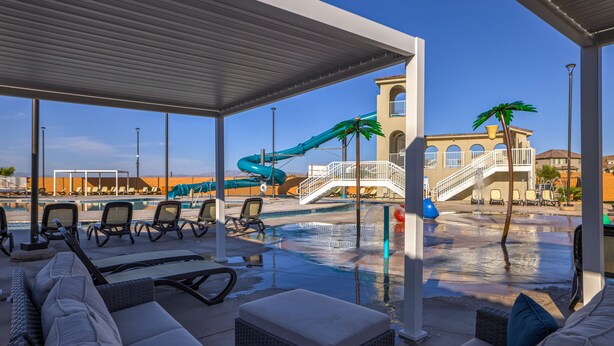 A covered pool area with lounge chairs, a water slide, and a palm tree. - 2 MASTER BEDROOMS! 4 Bed 4 Bath Townhome (Washington)