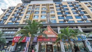 A multi-story hotel with balconies, a restaurant, and a signboard with contact information. - Lanmei Riverside Holiday Hotel (Jinghong)