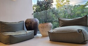 A modern living area with two grey sofas and a large decorative vase.