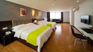 A hotel room with two beds, a desk, a chair, a TV, and a large window. - Jinchi Business Hotel (Jiangmen)