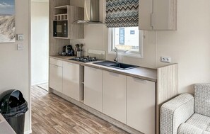 Fridge, stovetop, dishwasher, coffee/tea maker