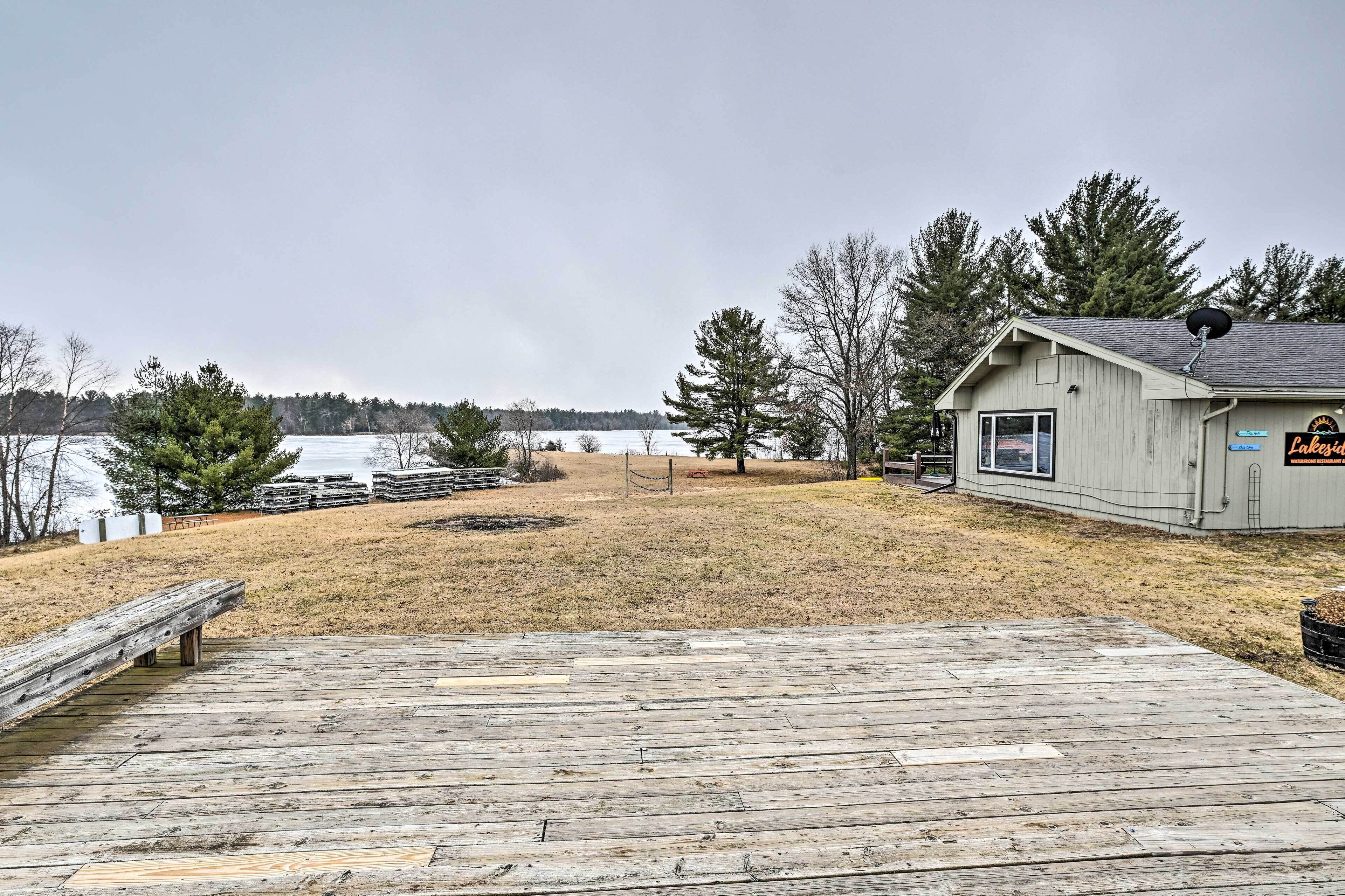 A wooden dock leading to a building with a sign that reads "Ski Lodge."