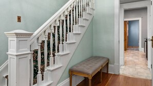 A staircase with white balusters and a wooden bench at the bottom. - Timelessly restored home - entirely yours to enjoy (Billings)