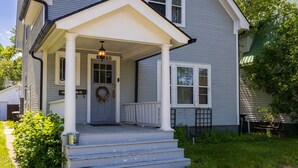 A two-story house with a front porch, a front door with a wreath, and a mailbox. - Timelessly restored home - entirely yours to enjoy (Billings)