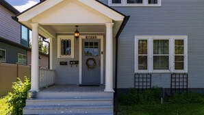 A two-story house with a front porch, a front door with a wreath, and a mailbox. - Timelessly restored home - entirely yours to enjoy (Billings)