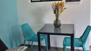 A dining area with a table and chairs, a vase with flowers, and a large mirror on the wall. - Property in peaceful, central countryside (Ducos)