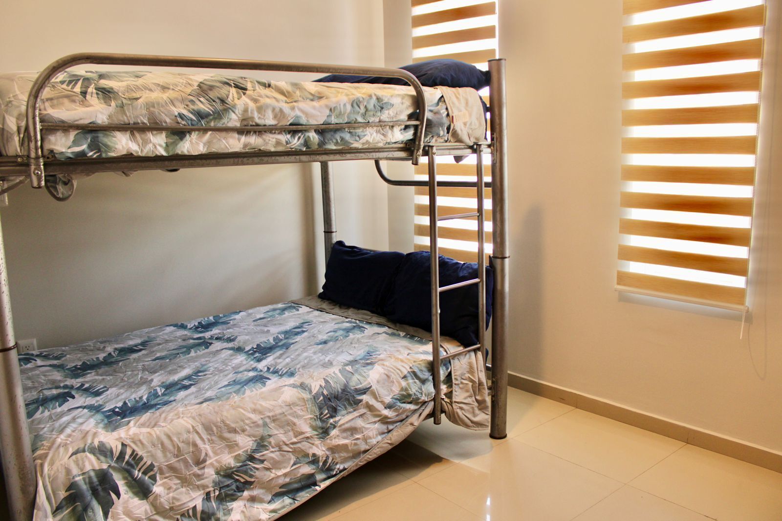 A bunk bed with a floral-patterned mattress and a ladder.