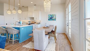 A spacious kitchen with a central island, pendant lighting, and a large window. - Private Heated Pool, Golf Cart Included, Pet Friendly (Port Aransas)
