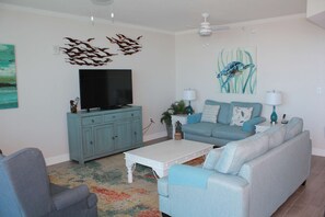 A living room with a TV, sofa, and coffee table.