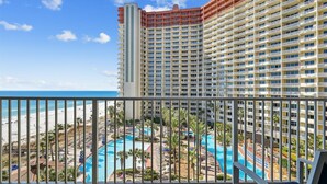 A hotel with a pool area, beach view, and multiple balconies. - Shores Of Panama 726 - 1bd+bunks, Sleeps 6. Sunset View! Reserved Parking Space! Free Fun! 1 Bedroom Condo by RedAwning (Panama City Beach)