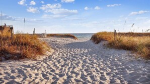 A sandy beach path leading to the sea, with dunes on either side and a wooden structure on the left. - Origin at Seahaven 1036/1038 - 2 Bedroom Unit 2 Home by RedAwning (Panama City Beach)