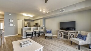 A modern apartment with a kitchen, dining area, and living room. - Shores Of Panama 1426 1 Bd+bunk Room, Sleeps 6. Renovated! Sunset View! Free Fun! 1 Bedroom Condo by RedAwning (Panama City Beach)