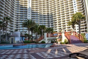 Surrounded by lush greenery and a tranquil pool area with a fountain, this hotel offers a serene escape.