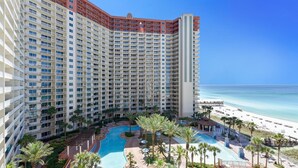 A high-rise hotel with a pool area and beach view. - Shores of Panama 808- 1 Bedroom+Bunk Room, Free Fun! Updated! Sleeps 6. 1 Condo by RedAwning (Panama City Beach)